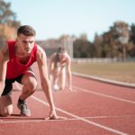 Space Race - Strong sportsmen ready for running on stadium