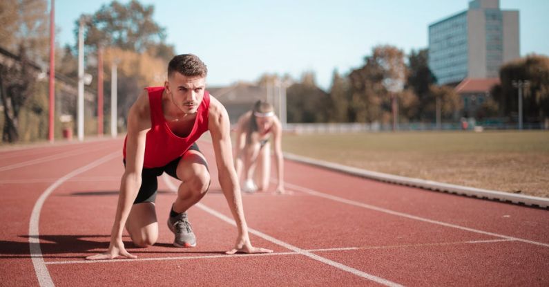 Space Race - Strong sportsmen ready for running on stadium