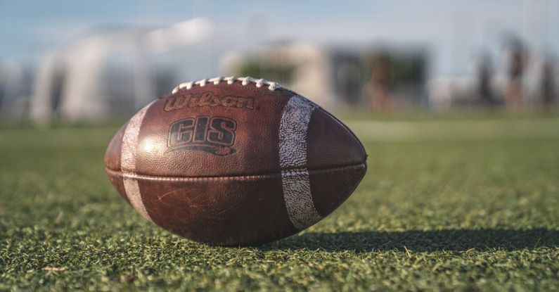 Football - Selective Focus Close-up Photo of Brown Wilson Pigskin Football on Green Grass