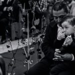 Funeral Customs - A man and a boy are sitting in a church