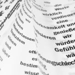 Written Language - From above of white sheets of paper with curled edges and black written words placed on white background in light room