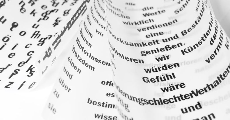 Written Language - From above of white sheets of paper with curled edges and black written words placed on white background in light room