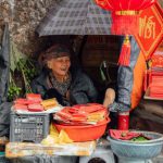 Chinese New Year - A Happy Woman Selling Chinese New Year Decorations