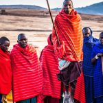 Maasai Tribe - Photo of Group of Men Wearing Assorted Scarves Holding Sticks
