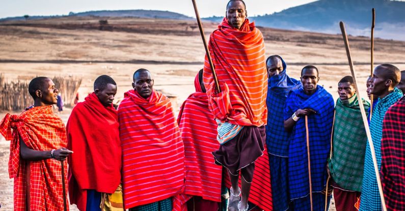Maasai Tribe - Photo of Group of Men Wearing Assorted Scarves Holding Sticks