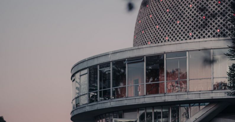 Scientific Breakthroughs - A building with a dome and a tree in front
