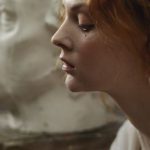 Renaissance Artists - Photo of a Woman Sitting Beside Statue