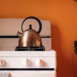 Ethiopian Cuisine - A white stove and oven in an orange kitchen