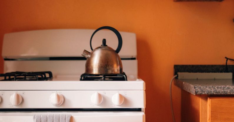 Ethiopian Cuisine - A white stove and oven in an orange kitchen