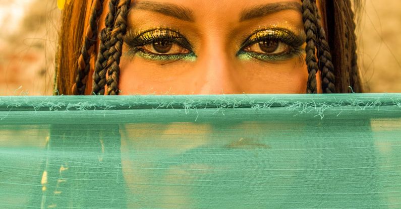 Egyptian Mythology - Woman with Makeup and Braided Hair behind Green Veil