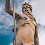 Roman Gods - Statue of Neptune against blue sky