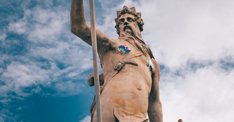 Roman Gods - Statue of Neptune against blue sky