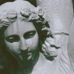 Celtic Mythology - Antique figure of young female in dress with hair tied up carrying vase on shoulders on blurred background